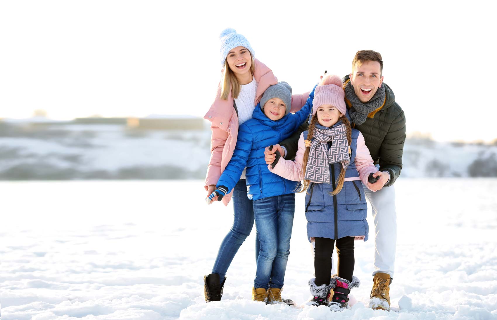 Photo: Family of four having fun in the snow.